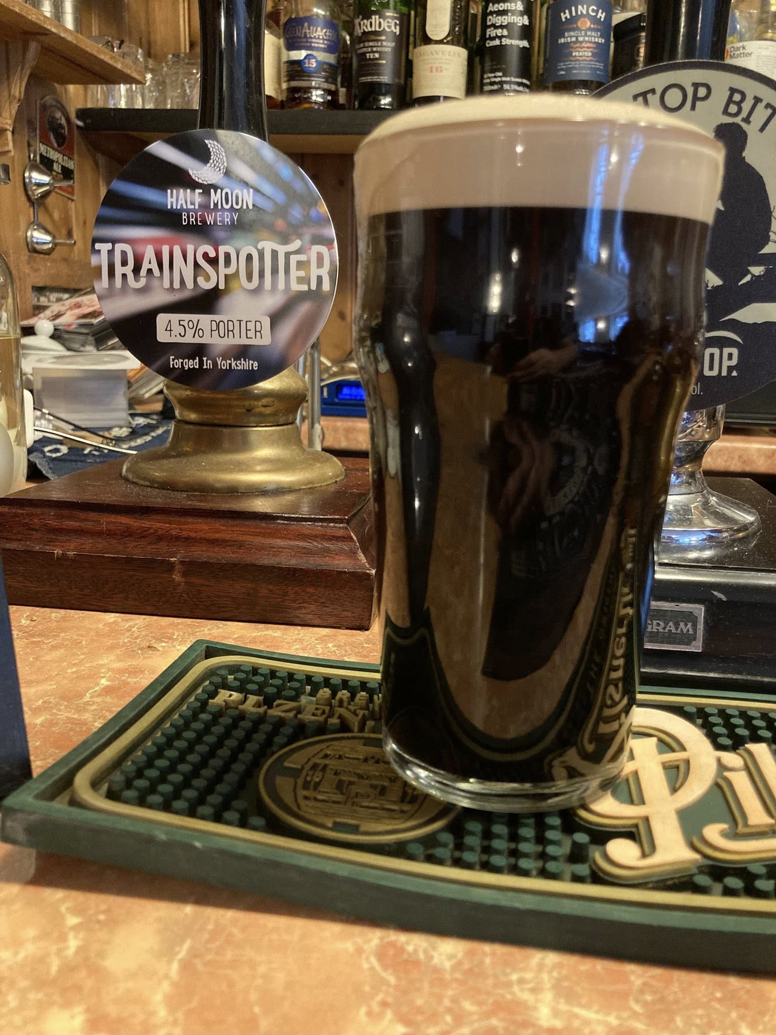 A pint of dark stout with a creamy head
